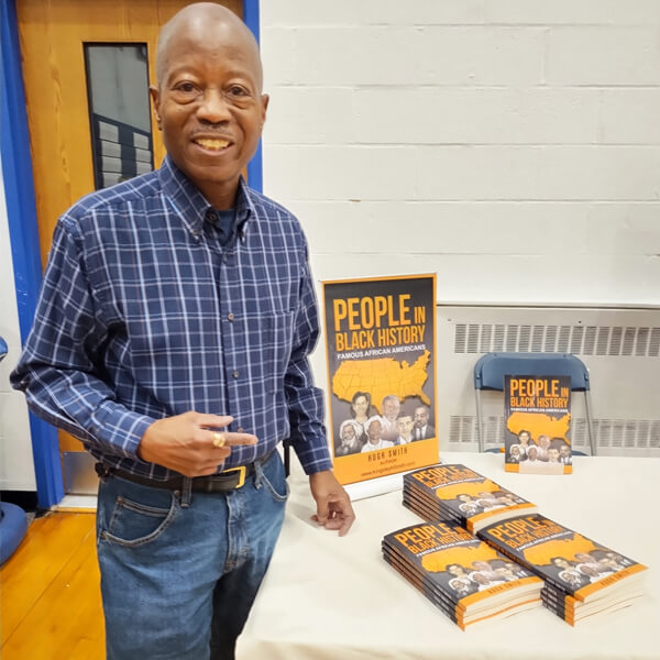 Kingsley H. Smith pointing at People In Black History Book